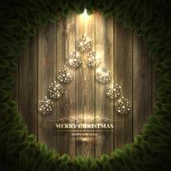 Christmas tree with bright baubles on Wooden background and wreath