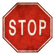 Old and rusty stop sign isolated on white