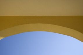 top of yellow arch at sky