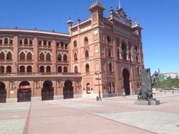 monument in front of arena building on plaza de toros, spain, madrid