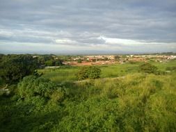 urban houses beyond green hill in nicaragua