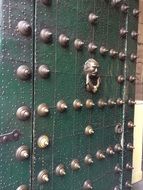 Old green door with the knocker in the Mexico