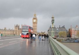 Red bus near big ben in the rainy London