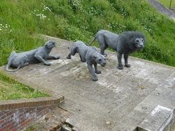 pride, grey stone sculptures in park, lions family, england, london