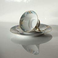 Cup on a saucer on a white surface