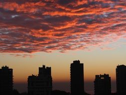 cityscape scene of red sunrise over the buildings