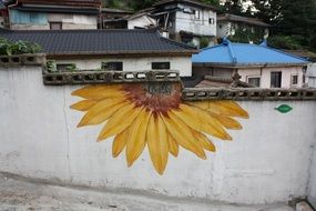 Sunflower graffiti on fence