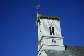 white clock tower at blue sky background