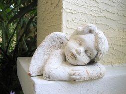 stone cherub as an old sculpture