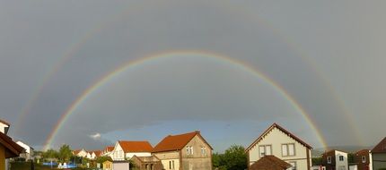 double rainbow above village