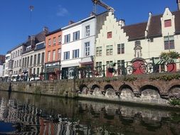 scenic terraced buildings mirroring on chanel, belgium, gent