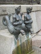 sculptures of water people in the fountain