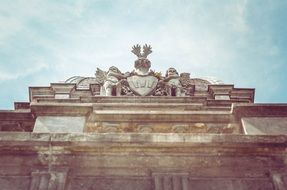 coat of arms with two angels on a building roof