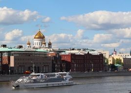 cityscape of church and boat on the river