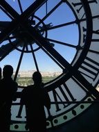 tourists near the huge clocks in paris