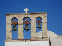 bells on the roof of a church in Greece