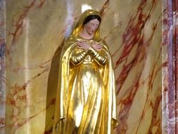 golden woman statue at church, france