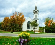 rural church among picturesque autumn with colorful plants