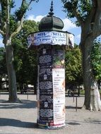 column of posters in a park