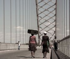 women walking away on bridge in Zimbabwe