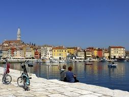 parked bicycles and people on the promenade in Piran