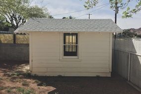 wooden shed near the fence