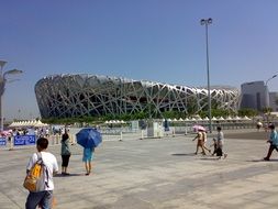 tourists near the modern stadium in china
