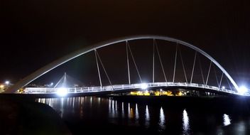 Illuminated modern bridge across the river