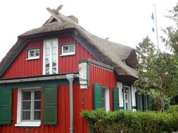 red house with reed roof on the Baltic Sea