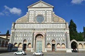 cars on the road in front of a church in italy