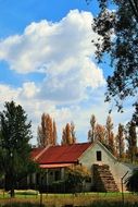 a small farm house and trees