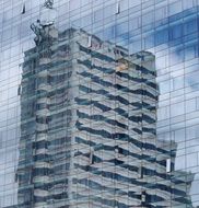 skyscraper reflected in a mirrored building