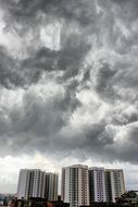 severe gray clouds over high-rise buildings