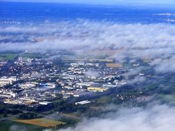 view of earth from an airplane through the clouds