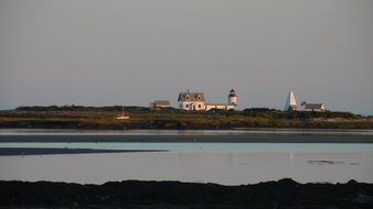 old light house on island at sunset