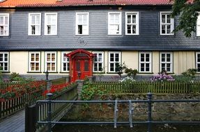 two story house with red door, germany