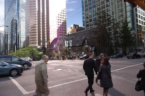 people on the road near the skyscraper in vancouver