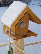 bird seed house covered by snow
