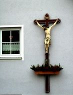 Cross with Jesus on church building with the plant pot