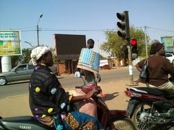 African woman on moped