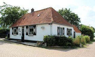 white village cottage with tile roof, netherlands, batenburg