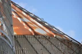 Metal roof with rust and blue sky