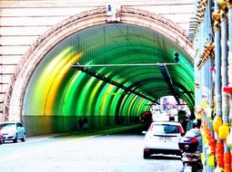 rainbow colored tunnel with city road