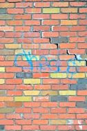 inscription on a colored brick wall