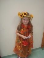 child with sunflowers on a head