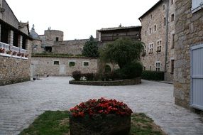 flower beds in the courtyard of an old building