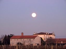 full bright moon at dusk over borgo