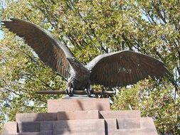 statue of a bird in the sun