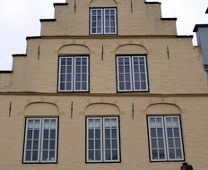 photo of Facade of an old house with windows