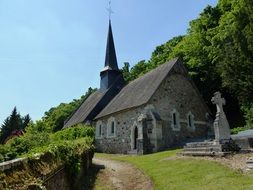 church in france among green grass